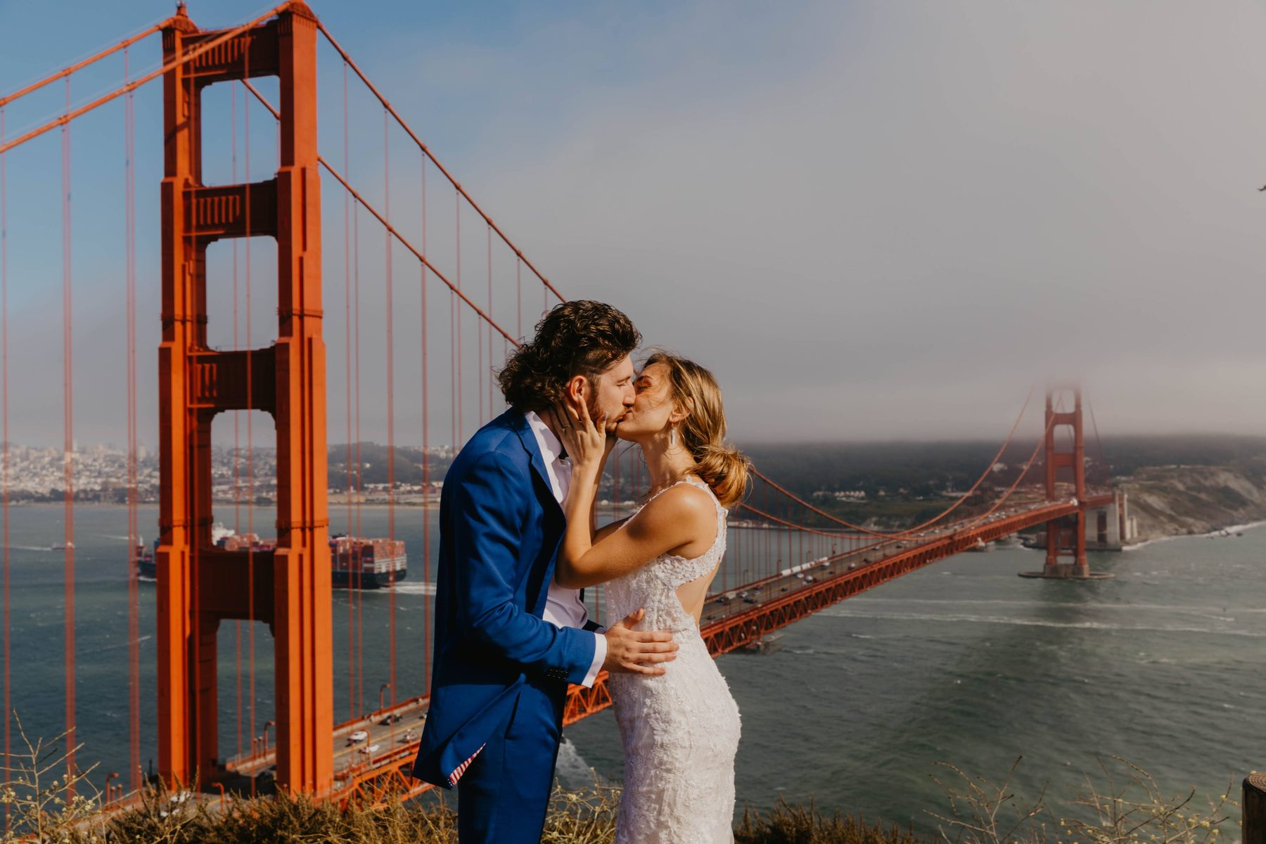 Newlyweds embracing with the Golden Gate Bridge behind them — Dejeu Crew wedding photography