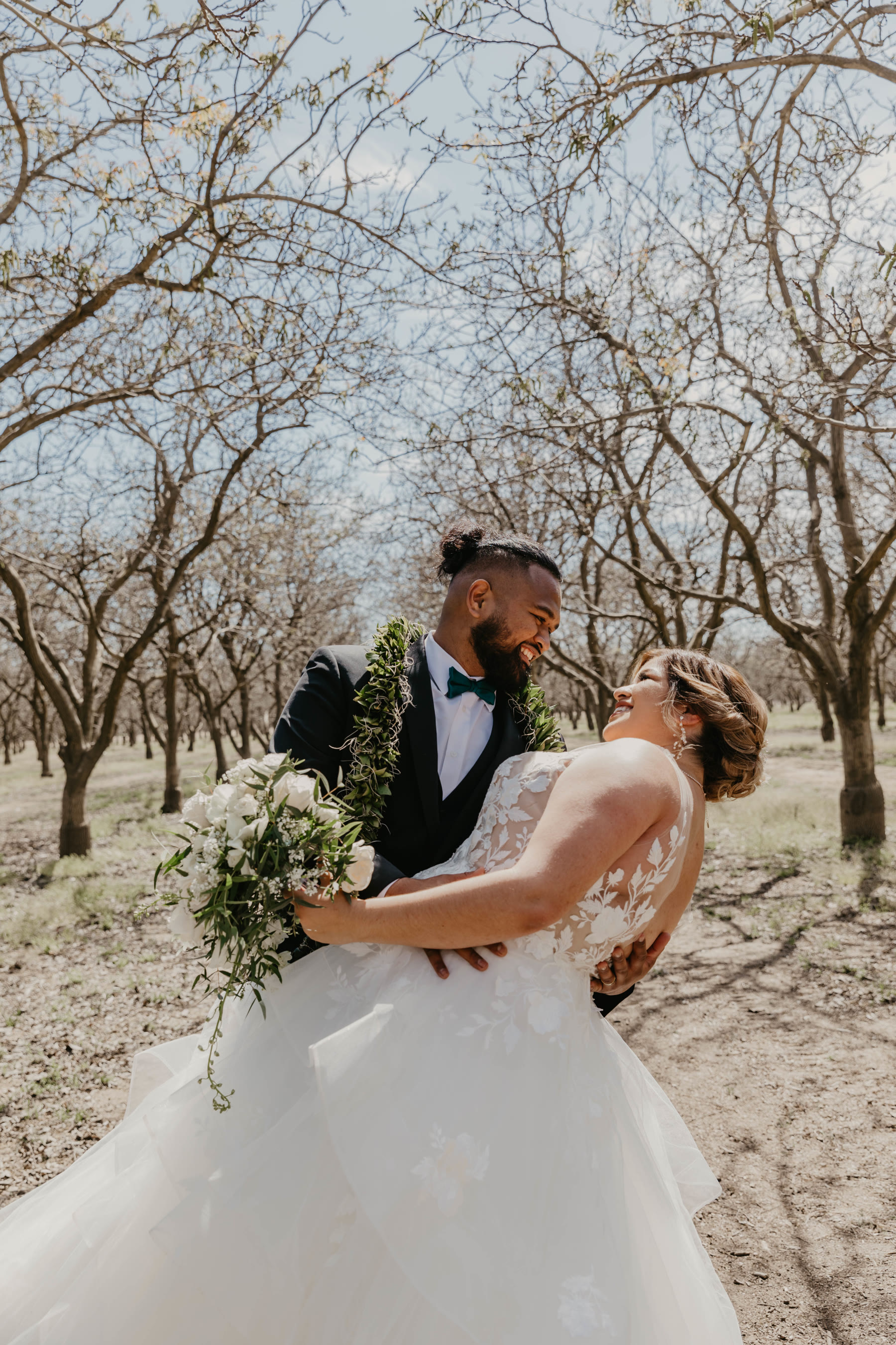 Groom dipping his laughing bride in an orchard after the ceremony — Dejeu Crew wedding photography